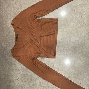 This shirt has a low cut, snatches everything in and looks good with anything.